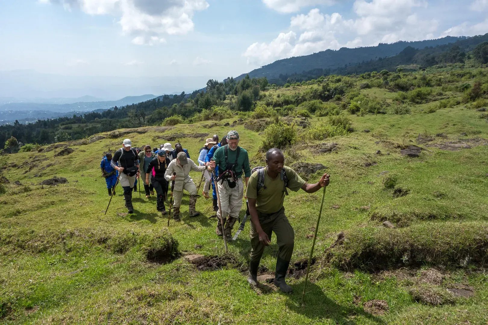 Ein Guide führt eine Gruppe von Touristen einen Berg hinauf.